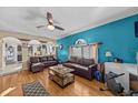 Open living room with brown leather sectional and views into kitchen at 2236 Sandridge Cir, Eustis, FL 32726