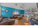 Spacious living room with brown leather couches and built in shelving units at 2236 Sandridge Cir, Eustis, FL 32726