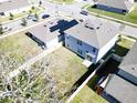 Two-story house with gray siding, solar panels, and a fenced backyard at 236 Talisi Loop, St Cloud, FL 34771