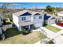 Two-story house with gray siding, solar panels, and a backyard at 236 Talisi Loop, St Cloud, FL 34771