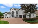 Beautiful two-story home has a brick driveway and detailed landscaping at 408 Chelsea Ave, Davenport, FL 33837