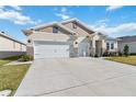 Two-story house with a three-car garage and landscaped yard at 6922 Audobon Osprey Cv, Harmony, FL 34773