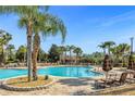 Relaxing resort-style pool with lounge chairs and palm trees at 8801 Worldquest Blvd, Orlando, FL 32821