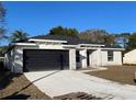 Newly built home with gray stone accents and a two-car garage at 102 Colomba Rd, Debary, FL 32713