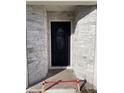 Stylish black front door with a glass oval window framed by gray stone at 102 Colomba Rd, Debary, FL 32713