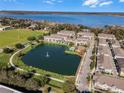 Attractive aerial view showcasing a well-maintained neighborhood with a pond, fountain, pool, and lake views at 1074 Clifton Springs Ln, Winter Springs, FL 32708