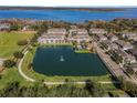 Aerial view of townhouses with lake access and a green space at 1074 Clifton Springs Ln, Winter Springs, FL 32708