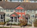 Townhouses with a mix of red and green exteriors, aerial view at 1074 Clifton Springs Ln, Winter Springs, FL 32708