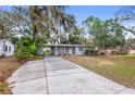 Charming Ranch style home with a large front yard and driveway at 1110 Oak Dr, Leesburg, FL 34748