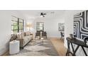 Bright living room with a beige sofa, a coffee table, and an abstract wall art piece at 1110 Oak Dr, Leesburg, FL 34748