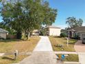 Two-story house with driveway and surrounding landscape at 1318 Lucky Pennie Way, Apopka, FL 32712