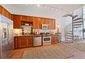 Modern kitchen with stainless steel appliances and wood cabinets at 150 E Robinson St # 14A, Orlando, FL 32801