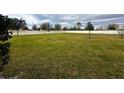 Spacious grassy backyard with a white vinyl fence at 15343 Willow Arbor Cir, Orlando, FL 32824