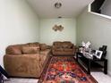 Small living room with two brown sofas and an area rug at 15343 Willow Arbor Cir, Orlando, FL 32824