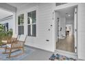 Front porch with rocking chairs and view into the house at 210 Hammock Preserve Loop, Winter Garden, FL 34787