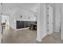 Light hallway with dark wainscoting and hardwood floors at 210 Hammock Preserve Loop, Winter Garden, FL 34787