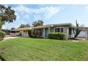 Attractive single-story home with a well-manicured lawn and lovely landscaping under a bright sky at 213 Oakland Ave, Sanford, FL 32773