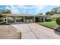 Inviting one-story home with a covered porch and spacious carport, offering a blend of comfort and functionality at 213 Oakland Ave, Sanford, FL 32773