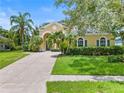 House exterior featuring a landscaped yard and driveway at 2764 Kingston Ridge Dr, Clermont, FL 34711