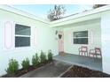 Inviting front porch with pink chairs and freshly painted door at 30 Old Barn Way, Casselberry, FL 32707