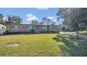 Tan house with green lawn and paved driveway at 3020 Nancy St, Orlando, FL 32806