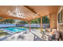 Relaxing covered patio with pool and seating area at 3020 Nancy St, Orlando, FL 32806