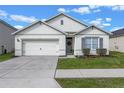 Curb appeal! This one-story home features a two-car garage and well-manicured lawn at 3101 Royal Tern Dr, Winter Haven, FL 33881