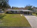 Ranch home with carport, and nicely landscaped yard at 402 Oak Lynn Dr, Orlando, FL 32809