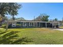 Charming ranch home with a carport and well-manicured lawn at 402 Oak Lynn Dr, Orlando, FL 32809