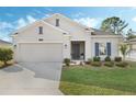 One story home with a two-car garage and nicely landscaped front yard at 4530 Tahoe Cir, Clermont, FL 34714