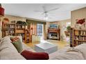 Bright living room with a fireplace, built-in shelving, and hardwood floors at 5408 Kalmia Dr, Orlando, FL 32807