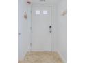 Bright condo entry with white door and beige tile floor at 5501 S Atlantic Ave # 4150, New Smyrna Beach, FL 32169