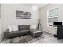 Living room features gray sectional sofa and large artwork at 6145 Citrus Grove Ct, St Cloud, FL 34771