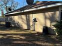 Side view of house showcasing AC unit and satellite dish at 7047 Sw 131St Loop, Ocala, FL 34473