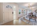 Inviting foyer leading to the dining and living areas with updated flooring and decorative lighting at 7884 Broken Arrow Trl, Winter Park, FL 32792