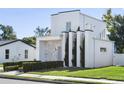 Stylish white house with gray stone accents and manicured hedges at 830 W Canton Ave, Winter Park, FL 32789