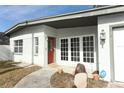 Front view of a house with a red door and white trim at 913 Carlson Dr, Orlando, FL 32804