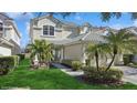 A charming two-story home featuring lush landscaping and a welcoming entrance at 9132 Via Bella Notte, Orlando, FL 32836