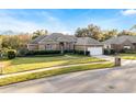 Brick house with a two-car garage and manicured lawn at 9451 Brownwood Ct, Oviedo, FL 32765