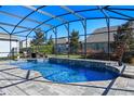 Relaxing kidney-shaped pool with a screened enclosure and water features at 9511 Nautique Ln, Winter Garden, FL 34787