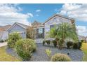 Stone and gray house with landscaping and driveway at 1040 Sadie Ridge Rd, Clermont, FL 34715