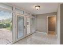 Bright entryway with tile floors and French doors leading to a patio at 106 Canterbury Dr, Haines City, FL 33844