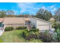 Single story home with stone facade and lush landscaping at 106 Canterbury Dr, Haines City, FL 33844