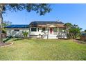 House exterior features a solar panel system and a spacious lawn at 1141 Edgewood Ranch Rd, Orlando, FL 32835