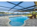 Stunning pool with covered patio and lake view at 1141 Edgewood Ranch Rd, Orlando, FL 32835