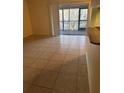 Living room with tile floors and access to a balcony at 1174 Paseo Del Mar # D # 32707, Casselberry, FL 32707