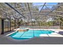 Screened in pool and spa with a view of the backyard at 13132 Coldwater Loop, Clermont, FL 34711