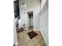 Tile entryway with staircase and coat closet at 196 Westmoreland Cir, Kissimmee, FL 34744