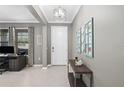 Bright entryway with a white door, gray walls, and decorative wall art at 2530 Domenico Paul Way, Orlando, FL 32810