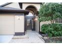 Front entry with a dark brown door and tile walkway at 2612 Keswick Ct, Kissimmee, FL 34744